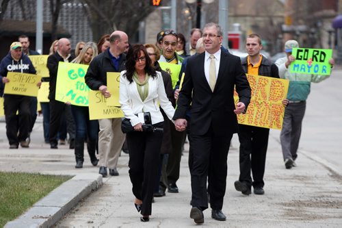 LOCAL ,Marching to City Hall ,is Gord Steeves  accompanied by his  wife Lorrie and a parade of supporters  signs paper to join the race for becoming Mayor og Winnipeg in  the next election  May 2 2014 / KEN GIGLIOTTI / WINNIPEG FREE PRESS