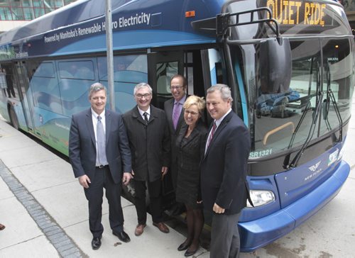 From left, Scott Thomson, president and CEO, Manitoba Hydro, Municipal Government Minister Stan Struthers, Mayor Sam Katz, Stephanie Forsyth, president and CEO, Red River College and Paul Soubry, president and CEO, New Flyer Industries in front of the first made in Manitoba prototype electric transit bus.    Bruce Owen story. Wayne Glowacki / Winnipeg Free Press May 2 2014
