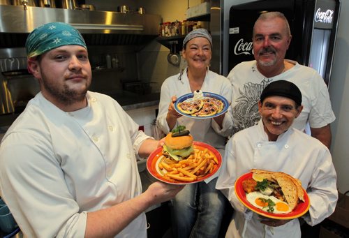 RESTAURANT REVIEW - Eye Opener Diner. Chefs Conrad Devigne,left, Frank Domiter, bottom right,  with owners Janet and Fred Bauer pose for a photo in the Restaurant on Main Street near the perimeter highway.  BORIS MINKEVICH / WINNIPEG FREE PRESS  May 2, 2014