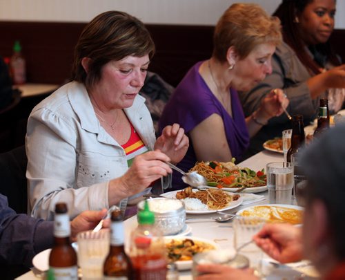 "Barb" who did't want her last name used, is a newcomer to the food club, spoons out delicacies at Magic Thai Wednesday evening. See Dave Sanderson story. May 7, 2014 - (Phil Hossack / Winnipeg Free Press)