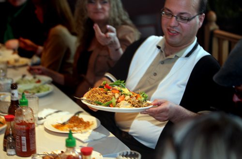 Gus Mauro passes a delicacy as the "Winnipeg Foodies" gathered to sample the fare at Magic Thai Wednesday evening. See Dave Sanderson story. May 7, 2014 - (Phil Hossack / Winnipeg Free Press)