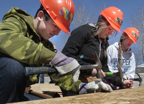 Stonewall Collegiate Institute students from left, Duncan Stewart, Steph Corbin and Krista Dupras were among the 85 students and 12 teachers from high schools taking part volunteering their time Friday to construct walls that will be used in Habitat homes this year. This is part of the High Schools for Habitat For Humanity (3H) program to foster the social consciousness of high school students and engage in advocacy of a very community minded organization like Habitat.   Wayne Glowacki / Winnipeg Free Press May 9 2014