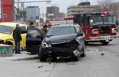 2  Vehicle MVC on Portage Ave at Burnell St.  left two vehicles heavily damaged and no injuries.leavng the bus lane blocked .  May 12 2014 / KEN GIGLIOTTI / WINNIPEG FREE PRESS