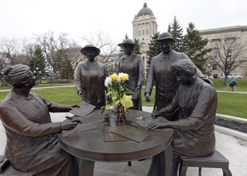 Stdup - Special days  , flowers were left at the Nellie McClung monument presumably for Mothers' Day on Sunday , today is Manitoba's 144th birthday all the more reason to keep the celebration going. May 12 2014 / KEN GIGLIOTTI / WINNIPEG FREE PRESS
