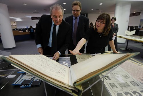 LtoR Ron Lemieux MLA and minister for Tourism , Culture , Heritage Sport and Consumer Protection  Provincial Archivist Scott Goodine , archivist  Kathlene Epp looking at Township plans from the 1870's to 1930's .  Lemieux announced the opening of a Manitoba Archives, launch of public exhibits, online displays to mark centenary of First World War at Home and Away  .through the archive blog , twitter  and new exhibit  with digital  access  through the archives Keystone data base  with 14,000 images  and 90 hours of audio .. May 12 2014 / KEN GIGLIOTTI / WINNIPEG FREE PRESS