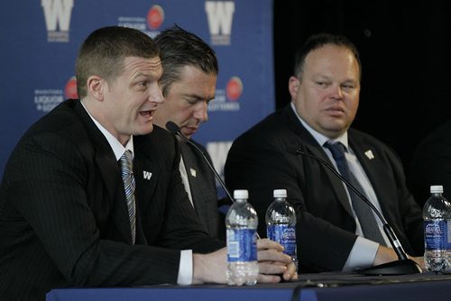 May 12, 2014 - 140512  - Mike O'Shea Winnipeg Blue Bomber head coach speaks as Kyle Walters,General Manager, and Wade Miller, President & Chief Executive Officer, listen in during Fan Fare at Investors Group Field  Monday, May 12, 2014.  John Woods / Winnipeg Free Press