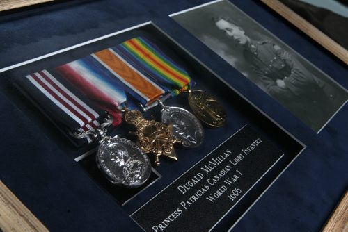 Photograph, medals and pay book belonging to Dugald McMillan, with Princess Patricia's Canadian Light Infantry in WW1 from early 1900's. War War one Memorabillia.  See 49.8 story.  May 13, 2014 Ruth Bonneville / Winnipeg Free Pres