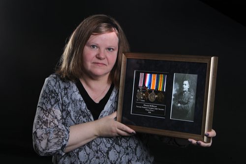 Photograph, medals and pay book belonging to Dugald McMillan, with Princess Patricia's Canadian Light Infantry in WW1 from early 1900's. War War one Memorabillia.  Margaret McMillan holds photo and medals belonging to her  grandfather.  See 49.8 story.  May 13, 2014 Ruth Bonneville / Winnipeg Free Pres