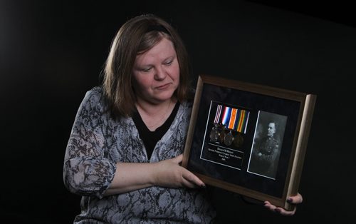 Photograph, medals and pay book belonging to Dugald McMillan, with Princess Patricia's Canadian Light Infantry in WW1 from early 1900's. War War one Memorabillia.  Margaret McMillan holds photo and medals belonging to her  grandfather.  See 49.8 story.  May 13, 2014 Ruth Bonneville / Winnipeg Free Pres