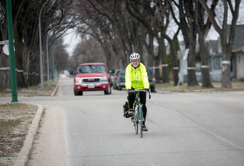 Bev Peters bikes down Powers Street in the north end of Winnipeg on her way to the North Star Diner.  Mary Agnes story on traffic and cyclists 140506 - Tuesday, May 06, 2014 - (Melissa Tait / Winnipeg Free Press)