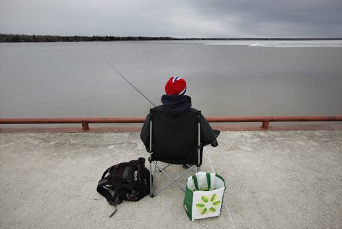 May 13, 2014 - 140513  - Kyle Otter tries his luck by throwing his line in a thawed section of Lake Winnipeg. Ice still covers Lake Winnipeg at Victoria Beach Tuesday, May 13, 2014.  John Woods / Winnipeg Free Press