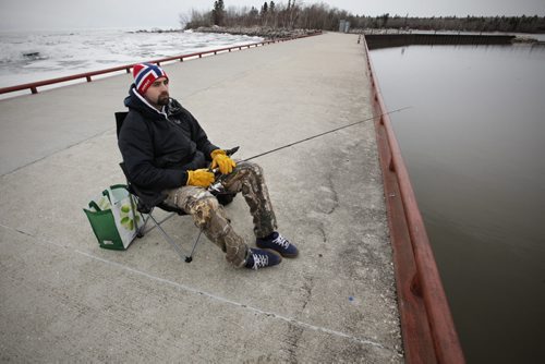 May 13, 2014 - 140513  - Kyle Otter tries his luck by throwing his line in a thawed section of Lake Winnipeg. Ice still covers Lake Winnipeg at Victoria Beach Tuesday, May 13, 2014.  John Woods / Winnipeg Free Press