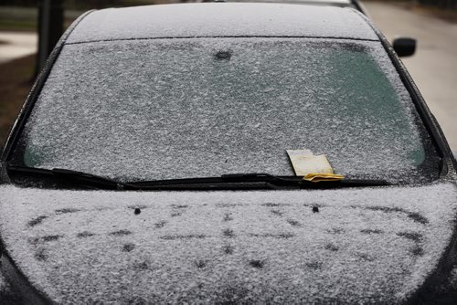 Stdup .Insult  added to injury , May Snow and a parking tickey on Wolseley Ave. Äì A light dusting of snow fell inside the city as the day began but melted almost as fast as it appeared . May 14 2014 / KEN GIGLIOTTI / WINNIPEG FREE PRESS