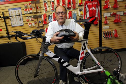 John Sawchuk, suffered multiple injures last Saturday when he crashed on his bicycle while doing a training ride for triathlon on Centreport highway (he hit a large hole and was thrown from the bike). Photo taken with a bike like his at  Alter Ego cycle shop an Pembina Highway. His red-and-white custom bicycle is still missing, a good samaritan offered to take it for him from the crash site, while he was being loaded into the ambulance on a spine board and stretcher with a neck brace, and return it to him later. He thought the person had his wife's cell phone number but he has not yet heard from the person and four days have passed. BORIS MINKEVICH / WINNIPEG FREE PRESS  May 14, 2014