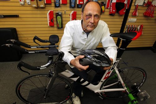 John Sawchuk, suffered multiple injures last Saturday when he crashed on his bicycle while doing a training ride for triathlon on Centreport highway (he hit a large hole and was thrown from the bike). Photo taken with a bike like his at  Alter Ego cycle shop an Pembina Highway. His red-and-white custom bicycle is still missing, a good samaritan offered to take it for him from the crash site, while he was being loaded into the ambulance on a spine board and stretcher with a neck brace, and return it to him later. He thought the person had his wife's cell phone number but he has not yet heard from the person and four days have passed. BORIS MINKEVICH / WINNIPEG FREE PRESS  May 14, 2014