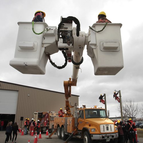 Students are lifted up in the Manitoba Hydro bucket truck.  About 1800 high school students attended the 6th annual Manitoba Construction Career Expo held at the Red River Exhibition Place. Students had an opportunity to try their hand at construction-related trades (welding, painting, roofing, piping ect.) at 34 interactive booths/displays.  see release Wayne Glowacki / Winnipeg Free Press May 14 2014