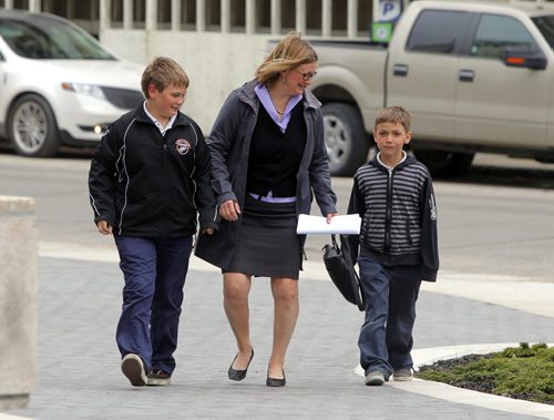 Paula Havixbeck registers to run for mayor. Her two boys (L) Nick and (R) Adrian came in with her. She was at City Hall, City Clerk's office, admin building. BORIS MINKEVICH / WINNIPEG FREE PRESS  May 14, 2014