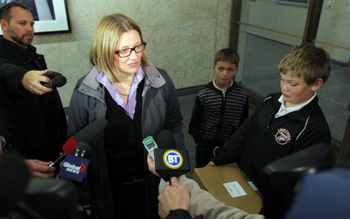 Paula Havixbeck registers to run for mayor. Her two boys Adrian and Nick came in with her. She was at City Hall, City Clerk's office, admin building. BORIS MINKEVICH / WINNIPEG FREE PRESS  May 14, 2014