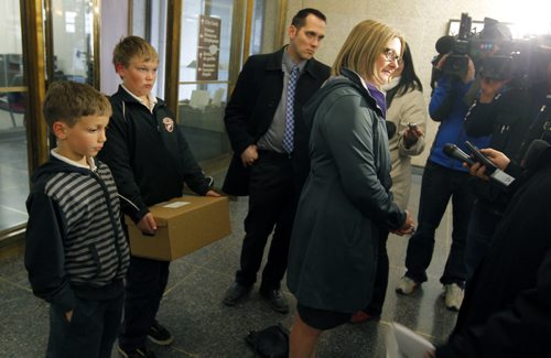 Paula Havixbeck registers to run for mayor. Her two boys Adrian and Nick came in with her. She was at City Hall, City Clerk's office, admin building. BORIS MINKEVICH / WINNIPEG FREE PRESS  May 14, 2014