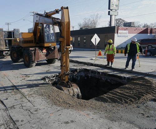 Stdup . The sinkhole on St. Mary's Rd.  at Morier Ave  is being repaired by city crews the  8x8ft x 6 ft deep  is being filled and traffic is getting around it . - May 15 2014 / KEN GIGLIOTTI / WINNIPEG FREE PRESS