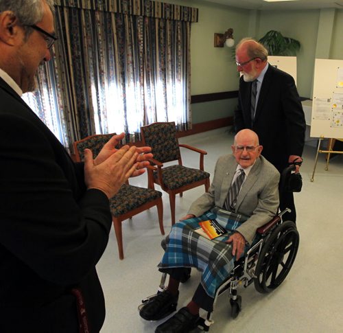 100 year old Leo D. Flood got his high school degree from St. Paul's Highschool. St. Pauls president Len Altilia on left, Gerald Flood on right. Presented to him at Misericordia Place. BORIS MINKEVICH / WINNIPEG FREE PRESS  May 15, 2014