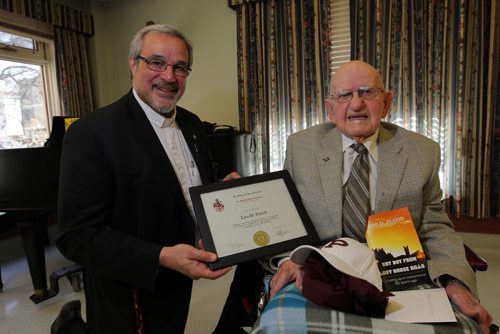100 year old Leo D. Flood, right, gets his high school degree from St. Paul's High school diploma by school president Len Altilia, left. It was given to him at a special presentation at Misericordia Place. BORIS MINKEVICH / WINNIPEG FREE PRESS  May 15, 2014