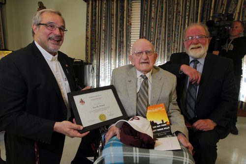 100 year old Leo D. Flood, centre, gets his high school degree from St. Paul's Highschool. Presented to him by school president Len Altilia, left, at Misericordia Place. Winnipeg Free Press Editorial Board editor Gerald flood is right in photo. BORIS MINKEVICH / WINNIPEG FREE PRESS  May 15, 2014