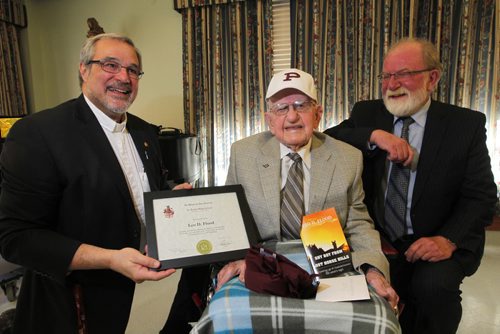 100 year old Leo D. Flood, centre, gets his high school degree from St. Paul's Highschool. Presented to him by school president Len Altilia, left, at Misericordia Place. Winnipeg Free Press Editorial Board editor Gerald flood is right in photo. BORIS MINKEVICH / WINNIPEG FREE PRESS  May 15, 2014
