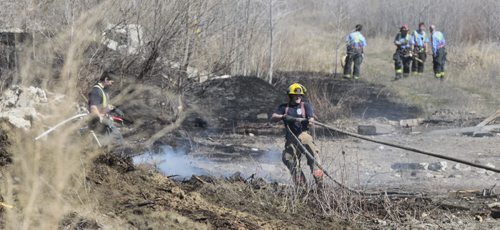 Winnipeg Fire Fighters extinguished a grass fire fanned by a light breeze Thursday afternoon near Terracon Place along the railway tracks. No damage to any structures.  Wayne Glowacki / Winnipeg Free Press May 15 2014