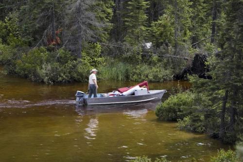 RED DEER KAKE - A cottager that lives on a neihbouring lake crosses a creek on the property of Steven and Merrilee Needam to get a boat load of supplies to his cottage.   Tom Thomsom for Winnipeg Free Press