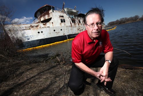 Mayor of Selkirk, Larry Johannson poses in front of the MS Lord Selkirk sitting listing and leaking into the Selkirk Slough. See Alex Paul story re salvage/demolition of the hazardous hulk. May 16, 2014 - (Phil Hossack / Winnipeg Free Press)