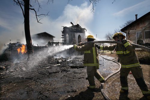 The Starbuck United Church in Starbuck, Manitoba caught fire and is a total loss Friday- It was built in 1906 Firefighters keep the fire under control near 3PM to prevent it from spreading to homes on either side of the structure- See  Randy Turner story- May 16, 2014   (JOE BRYKSA / WINNIPEG FREE PRESS)