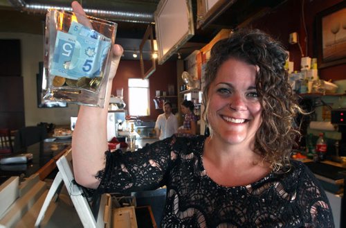 Jen Glenwright is writing Our Winnipeg for this Sunday. She is writing about her efforts to raise money for a fundraising 2,200 km bike in South America. She works at Cousins Deli, 55 Sherbrook St., and customers are filling up her tip jar with money for the trip.- See  Our Winnipeg- May 16, 2014   (JOE BRYKSA / WINNIPEG FREE PRESS)