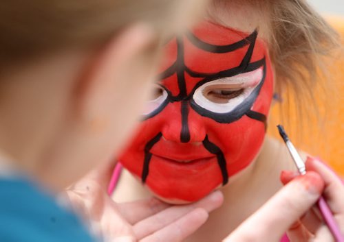 Three and a half year old Ainsleigh Powell checks herself out in the mirror after getting her face painted by artist Amy Coulling, a busker at the Forks Saturday afternoon. Standup photo May 17, 2014 Ruth Bonneville / Winnipeg Free Press