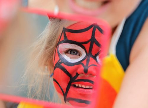 Three and a half year old Ainsleigh Powell checks herself out in the mirror after getting her face painted by artist Amy Coulling, a busker at the Forks Saturday afternoon. Standup photo May 17, 2014 Ruth Bonneville / Winnipeg Free Press