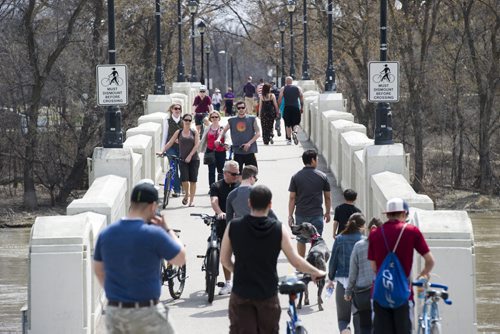 140517 Winnipeg - DAVID LIPNOWSKI / WINNIPEG FREE PRESS (May 17, 2014)  People make their way across the pedestrian bridge in Assiniboine Park on a warm Saturday afternoon.