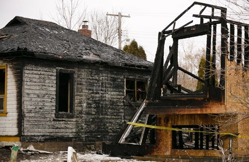 The scene of a fire damaged home on Jefferson Avenue near Scotia Street. In total four houses were damaged, fire and police continue to investigate.  140519 - Monday, May 19, 2014 - (Melissa Tait / Winnipeg Free Press)
