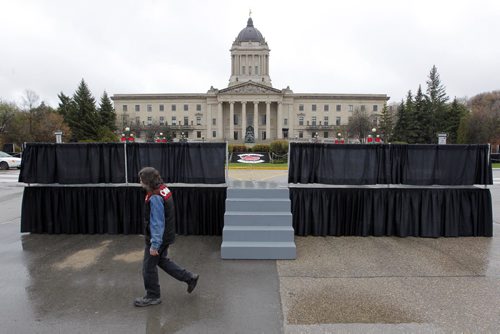 STANDUP - A man scoots by in front of the Legislature on Broadway. Various stages are set up for the Prince Charles' Royal Visit. BORIS MINKEVICH / WINNIPEG FREE PRESS  May 20, 2014