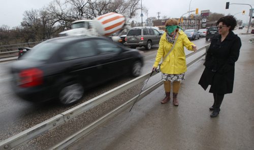 Jeannette Montufar- A traffic engineer at University of Manitoba points out problems at the intersection of Marion and Archibald  She blindfolded Free Press reporter Mary Agnes Welch to simulate how difficult it would be to navigate the intersection as a visual impaired pedestrian- See  Mary Agnes Welch story- May 20, 2014   (JOE BRYKSA / WINNIPEG FREE PRESS)