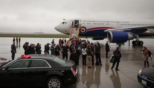 Prince Charles and Camilla, Duchess of Cornwall, arrive on the wet and windy tarmac at CFB Winnipeg Tuesday evening. The royal couple will visit Winnipeg for 27 hours. 140520 - Tuesday, May 20, 2014 - (Melissa Tait / Winnipeg Free Press)