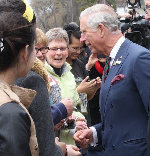 His Royal Highness Prince Charles  greets onlookers outside Place Bernadette Poirer meeting residents of the assisted living housing unit  - Bruce Owen story- May 21, 2014   (JOE BRYKSA / WINNIPEG FREE PRESS)