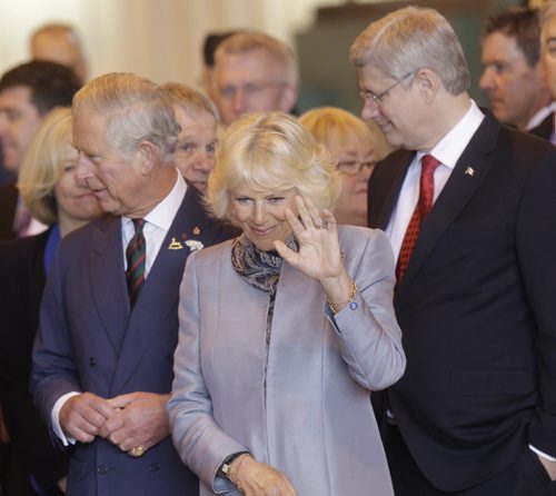 In Centre, Camilla, Duchess of Cornwall with Prince Charles and Prime Minister Stephen Harper waves to children at the Stevenson Hangar Wednesday morning.   Wayne Glowacki / Winnipeg Free Press May 21 2014