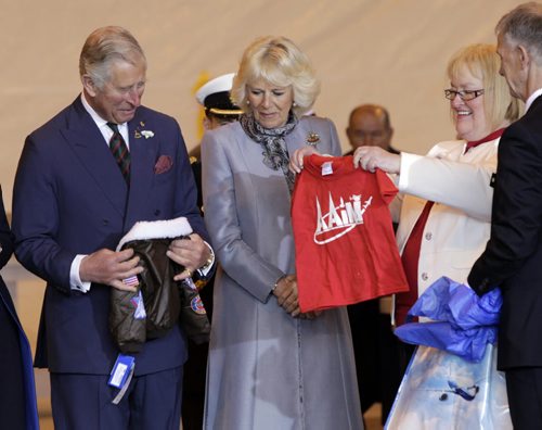 At right, Barb Bowen presents Prince Charles and Camilla, Duchess of Cornwall a flight jacket and a t-shirt for Prince George at the ceremony in the Stevenson Hangar Wednesday morning.   Wayne Glowacki / Winnipeg Free Press May 21 2014
