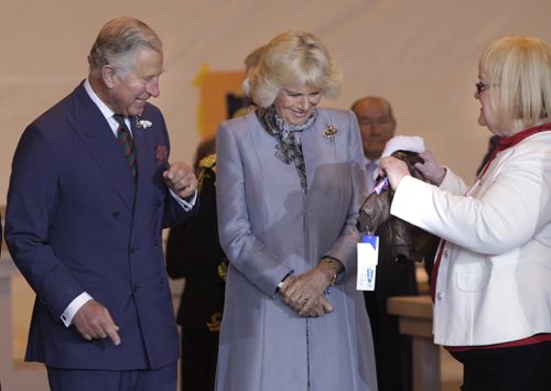 At right, Barb Bowen presents Prince Charles and Camilla, Duchess of Cornwall a flight jacket for Prince George at the ceremony in the Stevenson Hangar Wednesday morning.   Wayne Glowacki / Winnipeg Free Press May 21 2014