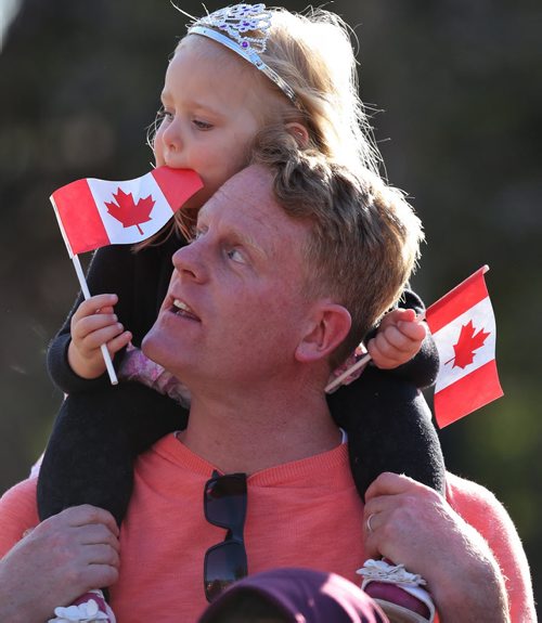 Kiri MacAulay, 3, on her dad Scott's shoulders waiting outside the Leislature for Prince Charles and Camilla. MELISSA TAIT PHOTO