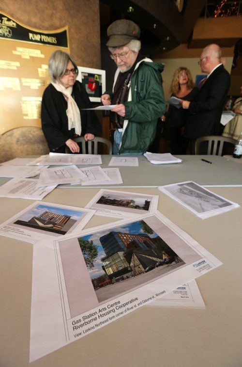 Visitors look over plans at a community consultation meeting at the Gas Station Art Centre on River Avenue at Osborne Street on Wed., May 21, 2014. PAL Winnipeg has been working with the Gas Station Art Centre and the Old Grace Hospital Housing Co-op to redevelop the River Avenue & Osborne Street site into a multi-faceted project that includes a theatre, commercial space and a housing component. Photo by Jason Halstead/Winnipeg Free Press