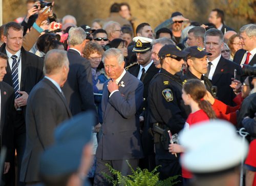Prince CHarles makes his way through the crowd surrounded by heavy security. May 21, 2014 - (Phil Hossack / Winnipeg Free Press)