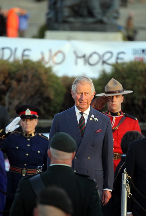 Prince Charles received full military honors while an Idle no More banner framed the party before departing Winnipeg Wednesday evening. May 21, 2014 - (Phil Hossack / Winnipeg Free Press)