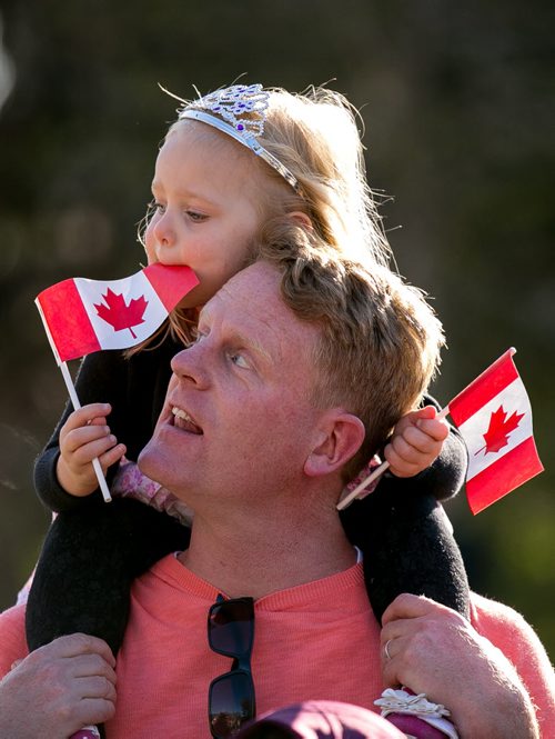 Kiri MacAulay, 3, waits patiently for the arrival of the Prince atop her dad Scott's shoulders at the Legislature Wednesday evening. More than 1000 people cheered for Prince Charles and Camilla, Duchess of Cornwall, as they made their final stop at the Legislature on a whirlwind 27-hour royal tour visit to Winnipeg. 140521 - Wednesday, May 21, 2014 - (Melissa Tait / Winnipeg Free Press)