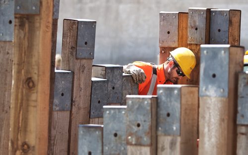 A Manitoba Hydro employee looks into the construction pit that is causing the redirection of traffic on Memorial Blvd Thursday afternoon.  140522 May 22, 2014 Mike Deal / Winnipeg Free Press